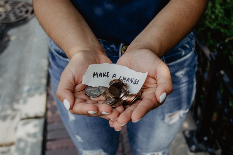 Hands holding change with "make a change" note