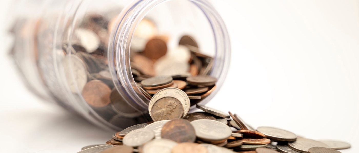 Coins spilling out of a jar