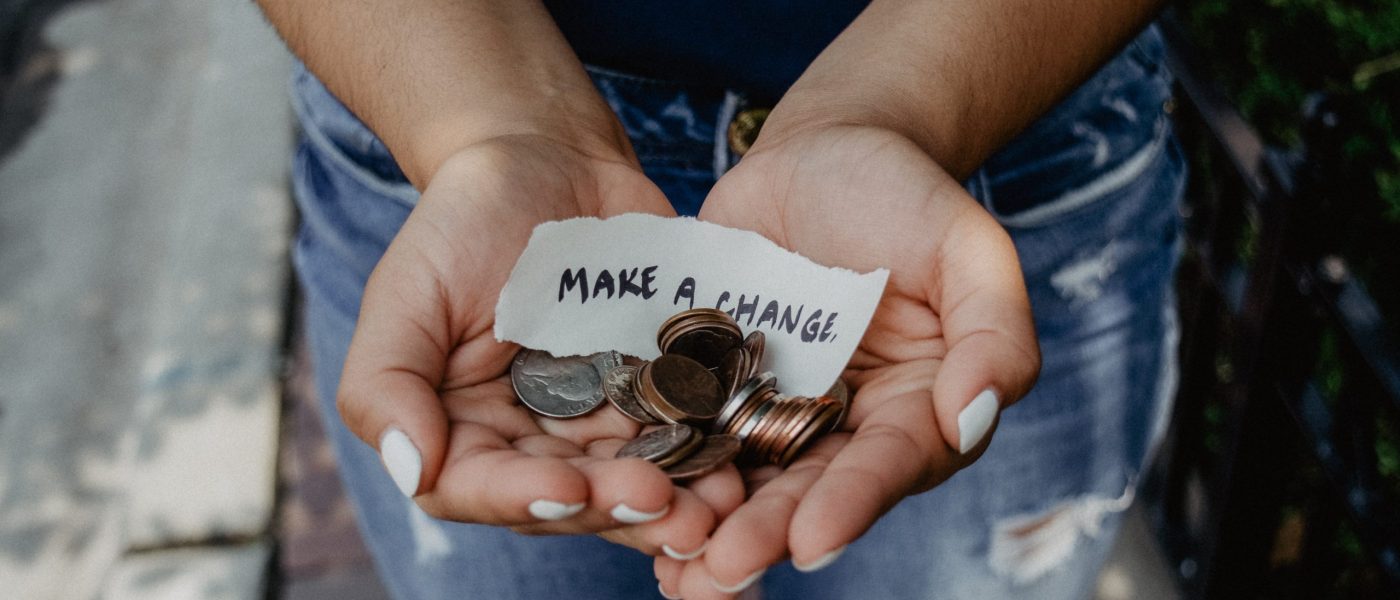 Hands holding change with "make a change" note
